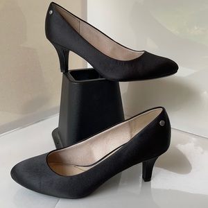 Black satin pumps with cushioned comfort sole.